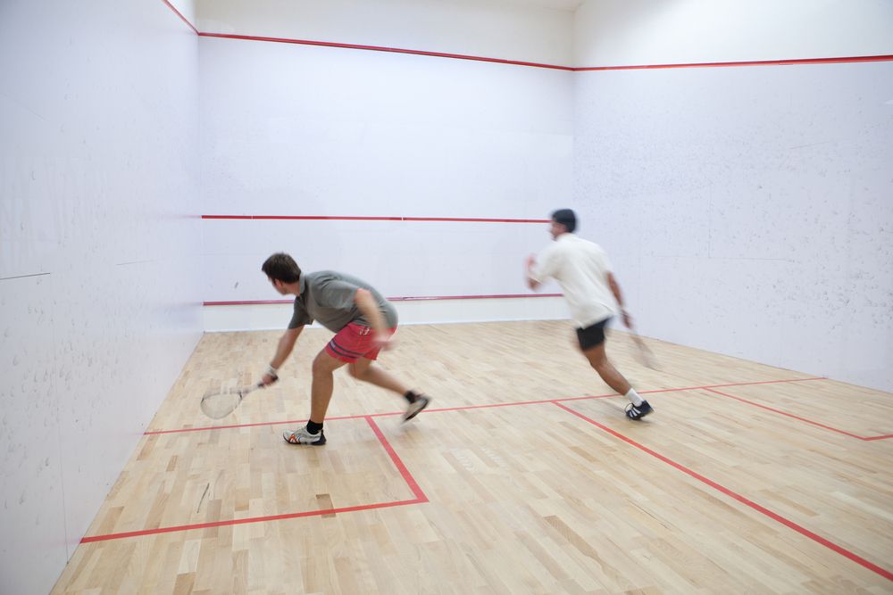 Squash,Players,In,Action,On,A,Squash,Court,(motion,Blurred