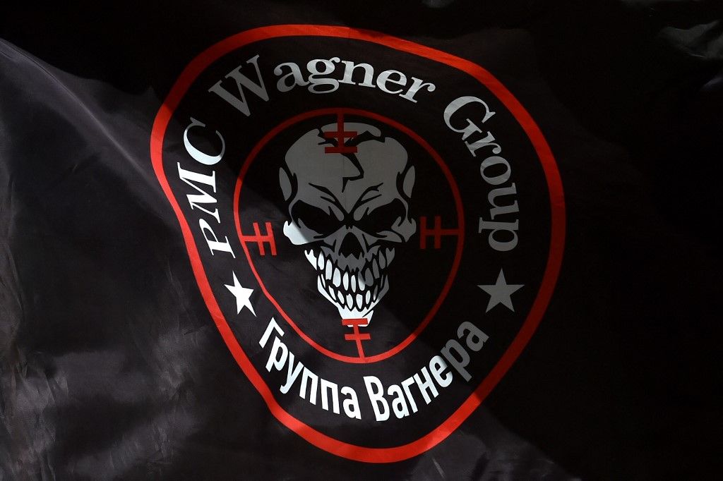 This photograph taken on August 24, 2023, shows a flag bearing the logo of private mercenary group Wagner as it flutters in the wind at a makeshift memorial in front of the PMC Wagner office in Novosibirsk, southern Russia. Russian state-run news agencies on August 23, 2023, said that Yevgeny Prigozhin, the head of the Wagner group that led a mutiny against Russia's army in June, was on the list of passengers of a plane that crashed earlier near the village of Kuzhenkino in the Tver region. (Photo by Vladimir NIKOLAYEV / AFP)