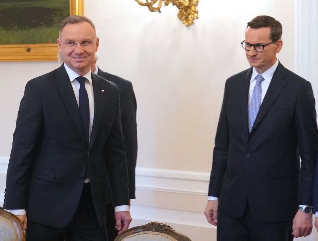 Polish President Andrzej Duda (L) meets with Prime Minister Mateusz Morawiecki from Poland's ruling conservative Law and Justice (PiS) party for talks about the creation of a new government, on October 24, 2023 in Warsaw, Poland, following the October 15 parliamentary election. (Photo by JANEK SKARZYNSKI / AFP)