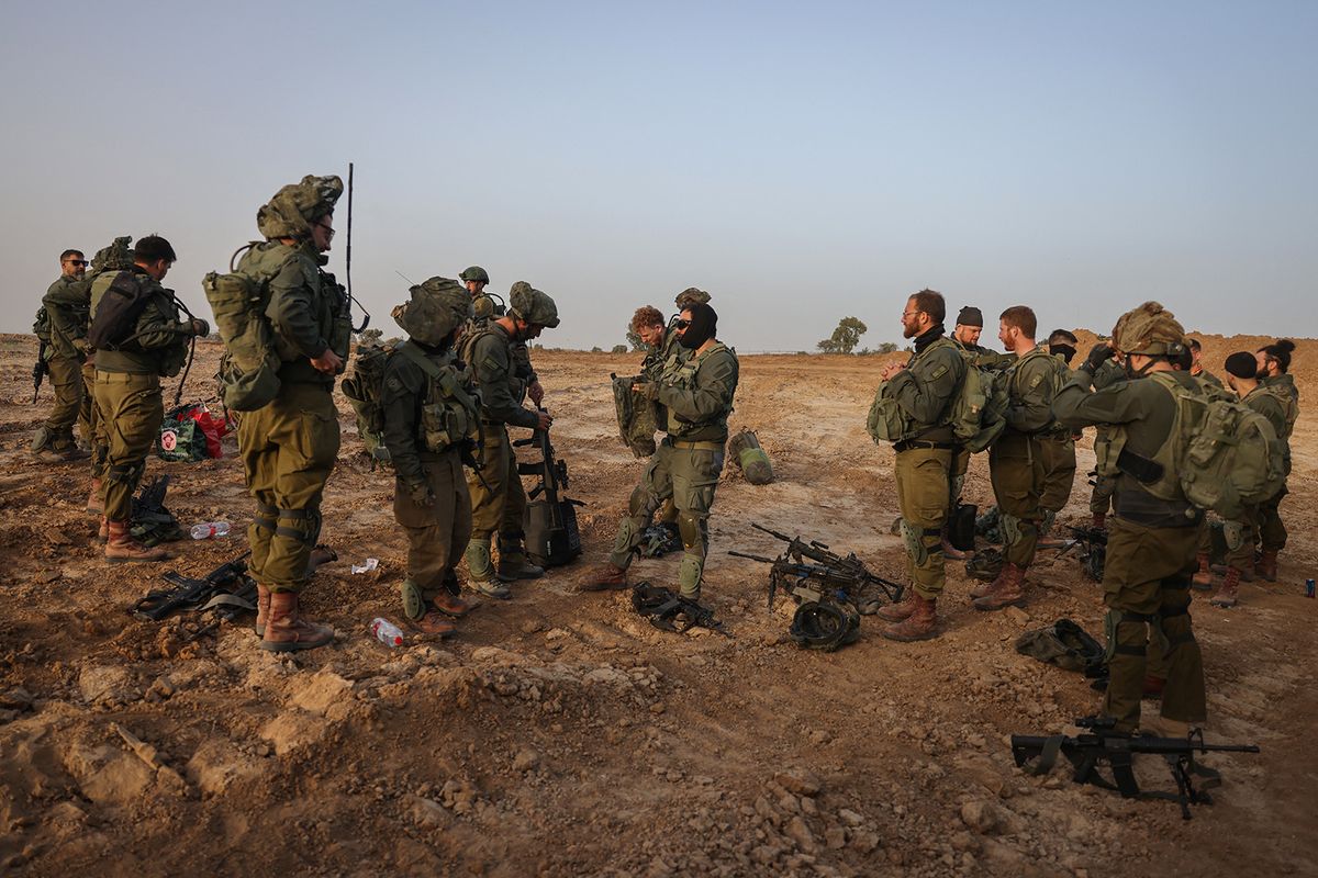 Israeli soldiers are pictured near the border with the Gaza Strip in southern Israel on November 26, 2023, amid a cease fire following weeks of battles between Israel and Palestinian Hamas militants. A four-day truce in the Israel-Hamas war took effect on November 24 under a deal that will see hostages released in exchange for Palestinian prisoners. (Photo by Menahem KAHANA / AFP)