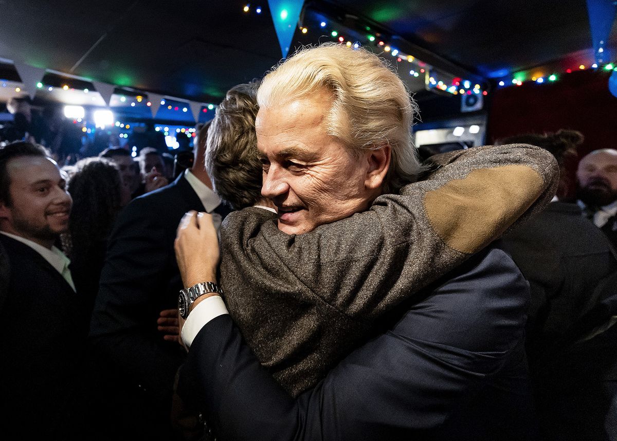 SCHEVENINGEN - PVV leader Geert Wilders is embraced by Martin Bosma after the announcement of the first exit poll of the results of the House of Representatives elections. ANP REMKO DE WAAL netherlands out - belgium out (Photo by REMKO DE WAAL / ANP MAG / ANP via AFP)