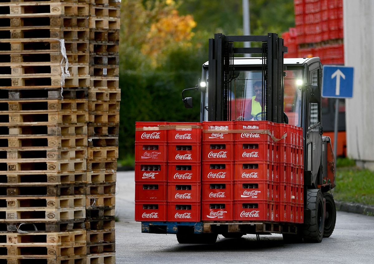 An employee drives a transpallette with bottles towards the filling station at the Coca Cola headquarters in Zagreb, Croatia, on November 8, 2023. The State Inspectorate ordered the removal of some Coca Cola products, after several cases of intoxication have been reported. (Photo by DENIS LOVROVIC / AFP)