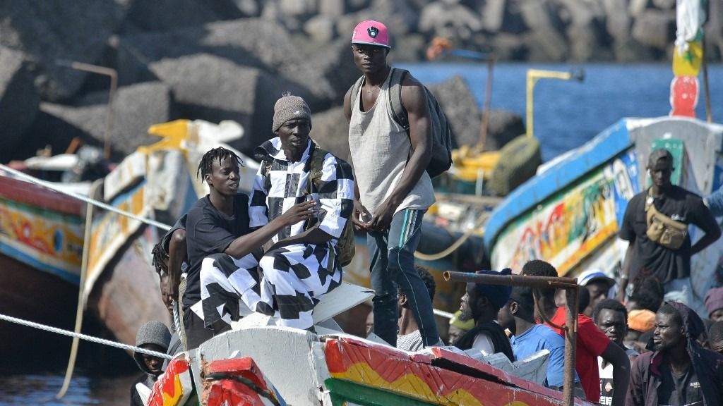 Migrants wait to disembark from a boat at La Restinga dock, in the municipality of El Pinar on the Canary Island of El Hierro, on October 31, 2023. El Hierro, the most westerly of Spain's Canary Islands in the Atlantic, is grappling with an unprecedented surge in migrant arrivals from Africa which have overwhelmed its social services. Around 6,000 migrants have arrived in this remote island -- which is home to just 11,000 people -- between January 1 and October 15, according to the latest interior ministry figures. (Photo by STRINGER / AFP)