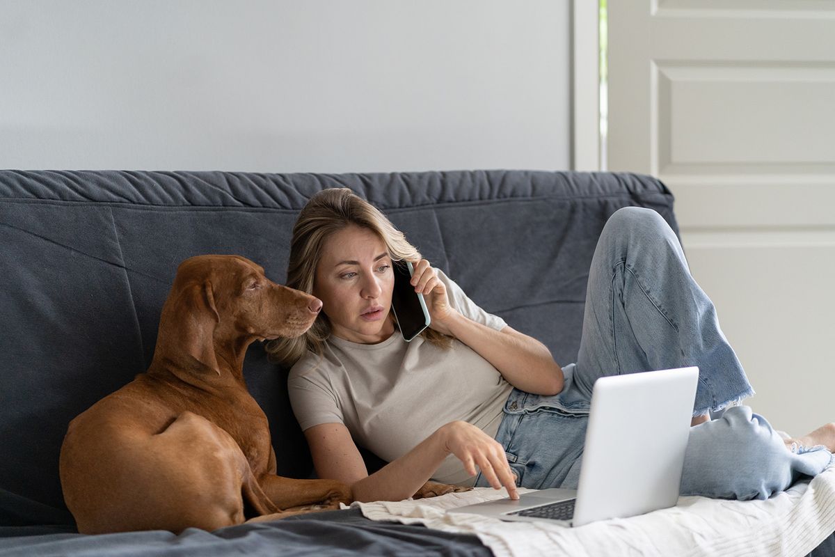 Woman,Lying,On,Couch,With,Her,Lovely,Vizsla,Dog,,Talking
