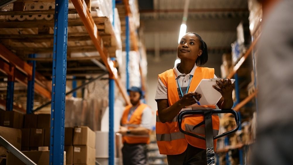African,American,Female,Worker,Going,Through,Inventory,List,While,Checking