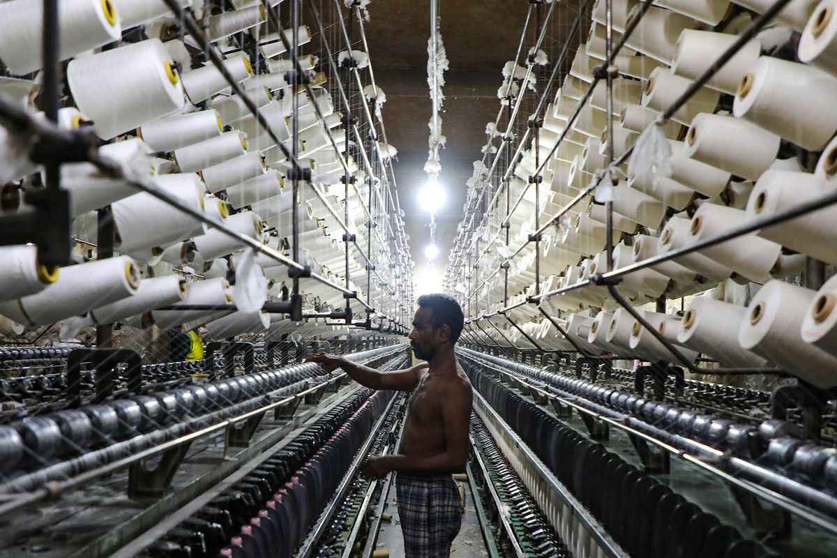 Workers manufacture thread for Ready-Made Garment Industry in a textile mill in Narayanganj outskirts of Dhaka, Bangladesh on September 02, 2023.  (Photo by Kazi Salahuddin Razu/NurPhoto) (Photo by Kazi Salahuddin Razu / NurPhoto / NurPhoto via AFP)