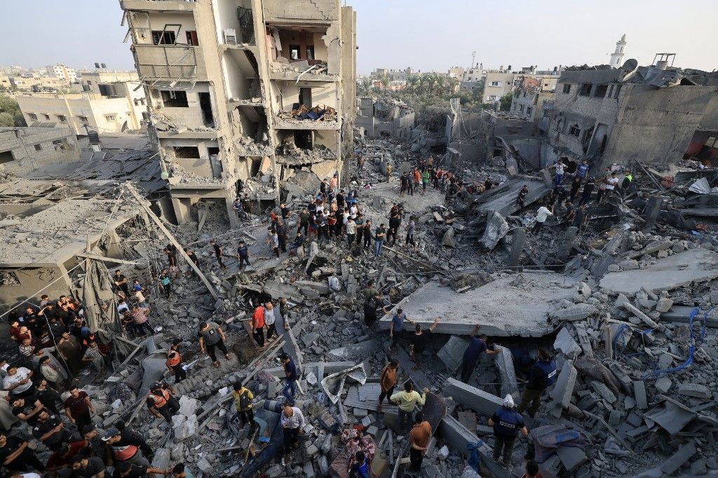 EDITORS NOTE: Graphic content / People check the damage caused by an Israeli strike on the Al-Maghazi refugee camp in Deir Balah in the central Gaza Strip, on November 5, 2023. The Hamas-run health ministry said, Israeli bombing of Al-Maghazi refugee camp killed 45 people, with an eyewitness reporting children dead and homes smashed. (Photo by Mahmud HAMS / AFP)