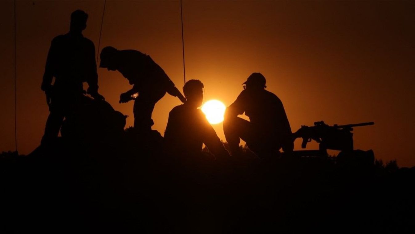 Israeli soldiers stand on the turret of a tank deployed on the southern border with the Gaza Strip on November 29, 2023, as a truce between Israel and Hamas entered a sixth day after a deal was extended to allow further releases of Israeli hostages and Palestinian prisoners. A current truce is scheduled to expire early on November 30, after a six-day pause in a conflict sparked by deadly Hamas attacks that prompted a devastating Israeli military offensive in the Gaza Strip. (Photo by Menahem KAHANA / AFP)