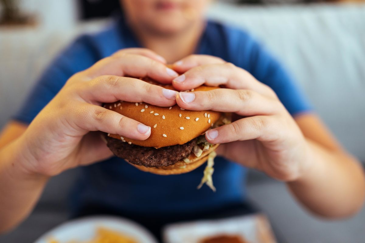 Hands is holding a fresh burger before eating