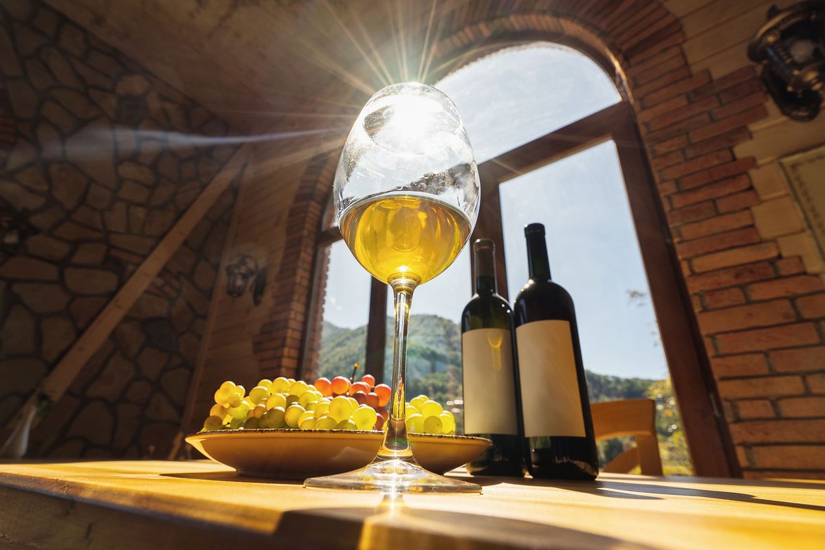 Wine,Bottles,,Grape,And,Glasse,Of,Wine,With,Sun,Rays