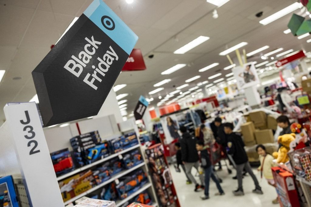 Black Friday sales signs are posted at a Target store in Rockville, Maryland, on November 25, 2022 . With inflation on the rise, retailers are expecting that many shoppers will be looking for especially good deals as discretionary spending falls. (Photo by SAMUEL CORUM / AFP)