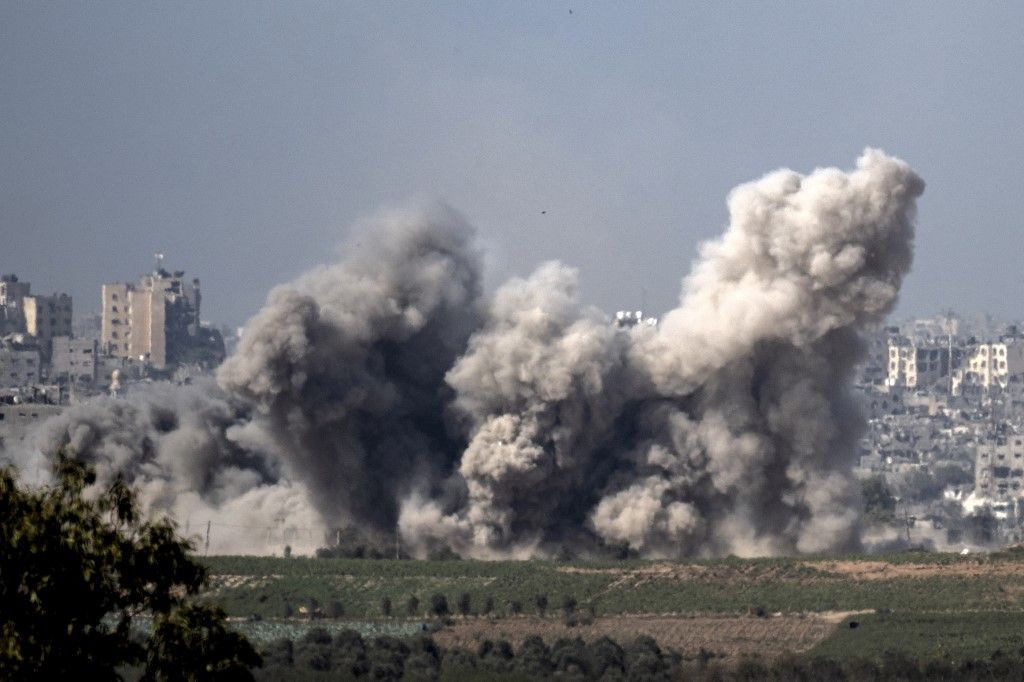 This picture taken from Sderot along the border with the Gaza Strip early on November 6, 2023, shows smoke rising from northern Gaza after Israeli strikes, amid ongoing battles between Israel and the Palestinian Hamas movement. (Photo by Aris MESSINIS / AFP)