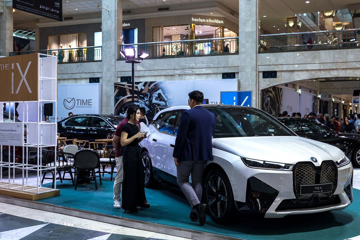 Inside The BMW All-Electric Vehicles Exhibition In Indonesia
Visitors talk near a BMW iX full-electric SUV vehicle during the exhibition in Jakarta, Indonesia on November 1, 2023. The exhibition is dedicated to showcasing and promoting electric vehicles (EVs) powered by renewable energy sources. BMW is the leading premium brand in Indonesia in the first 6 months of 2023, registering a 28% increase over 2022. Furthermore, the BMW iX is also Indonesia's best-selling luxury Electric Vehicle. (Photo by Garry Lotulung/NurPhoto) (Photo by Garry Lotulung / NurPhoto / NurPhoto via AFP)