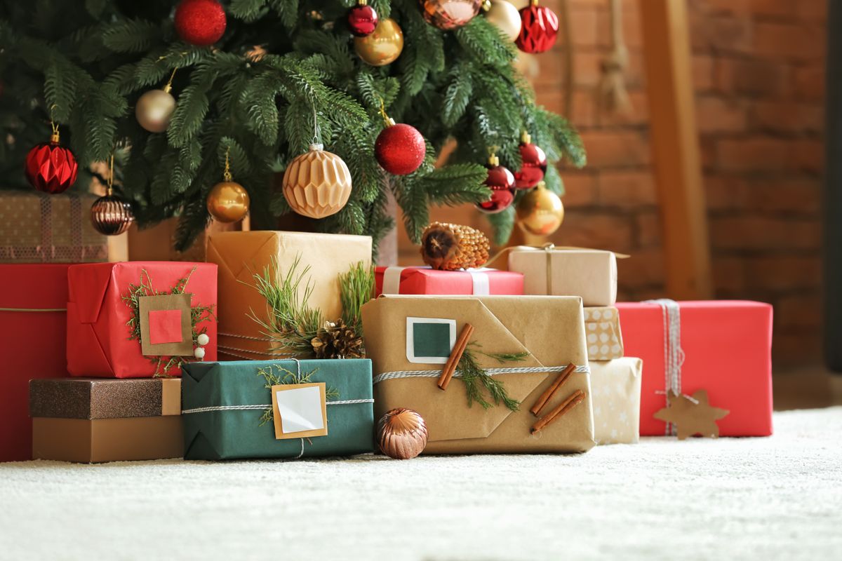 Beautiful,Christmas,Gifts,Under,Fir,Tree,On,Floor,In,Room