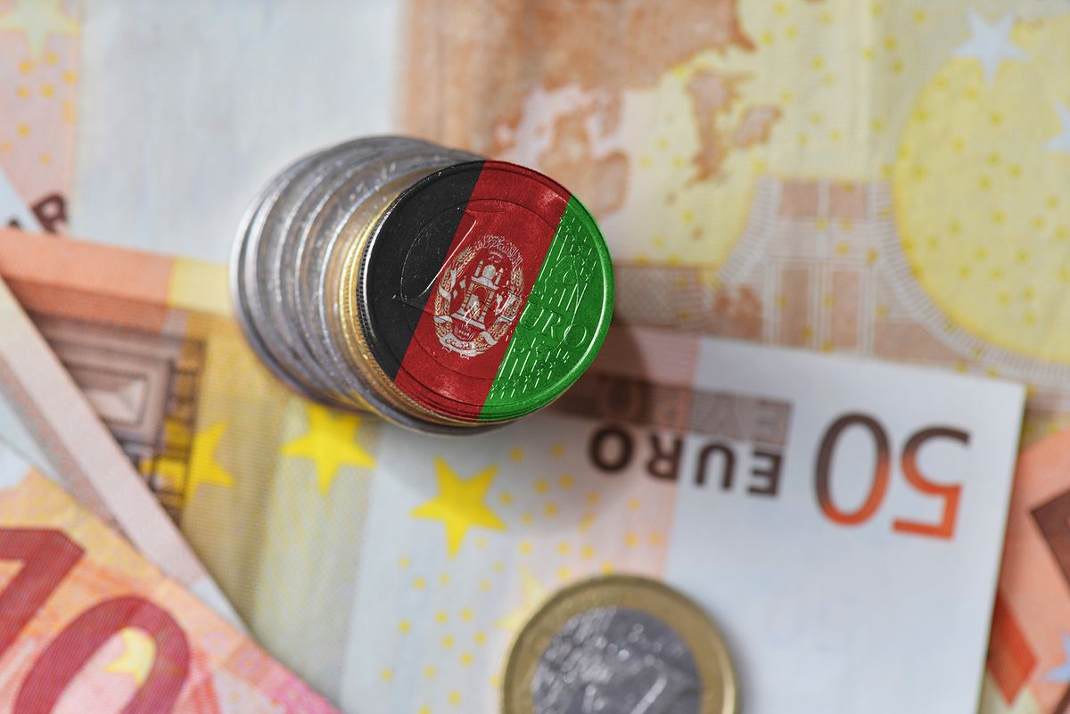 Euro,Coin,With,National,Flag,Of,Afghanistan,On,The,Euroeuro coin with national flag of afghanistan on the euro money banknotes background. finance concept