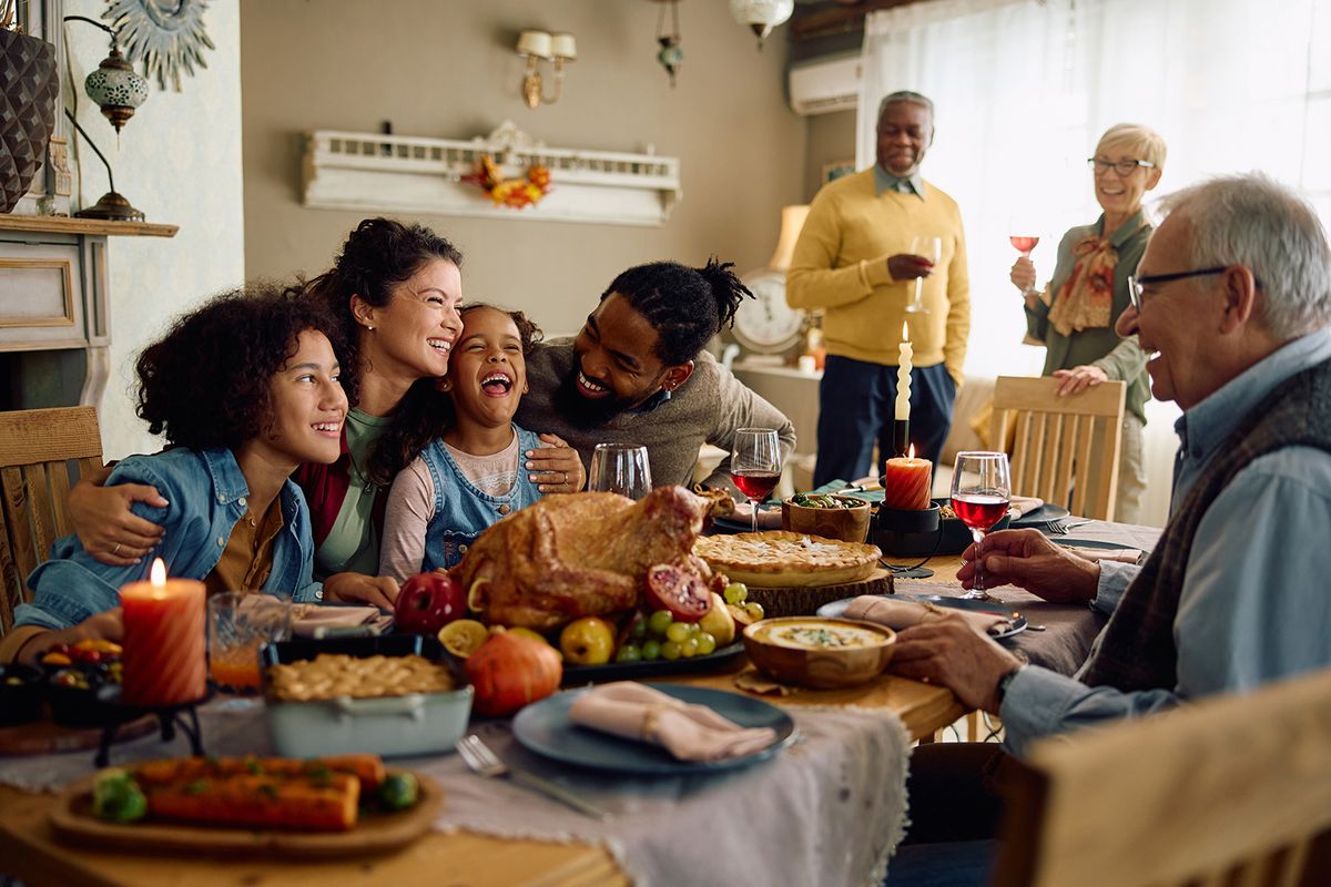 Happy,Multiracial,Parents,And,Their,Kids,Laughing,During,Family,Meal