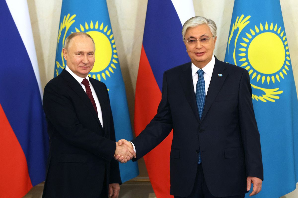 This pool photograph distributed by Russian state agency Sputnik shows Kazakhstan's President Kassym-Jomart Tokayev (R) shaking hands with Russia's president Vladimir Putin (L) during their meeting in Astana, on November 9, 2023. (Photo by Konstantin ZAVRAZHIN / POOL / AFP)