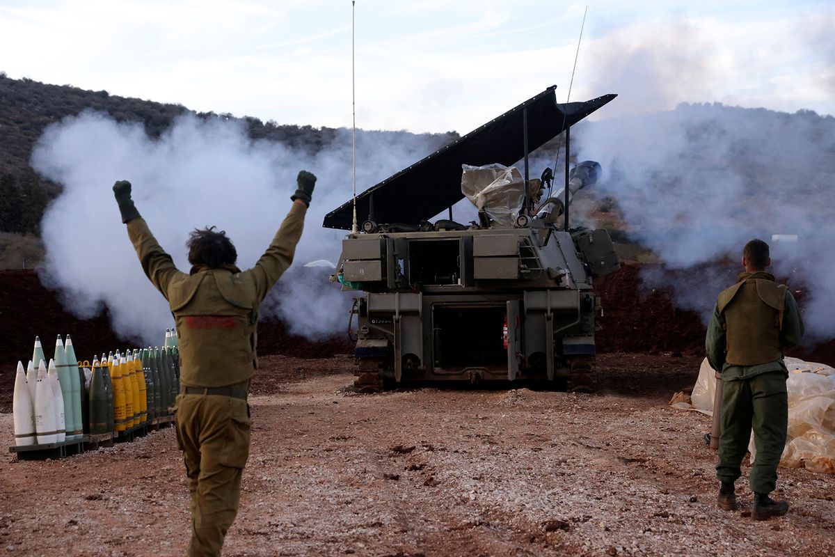 A soldier gestures as an Israeli artillery unit in Upper Galilee in northern Israel fires toward southern Lebanon on November 22, 2023,amid increasing cross-border tensions as fighting continues with Hamas militants in the southern Gaza Strip. (Photo by jalaa marey / AFP)