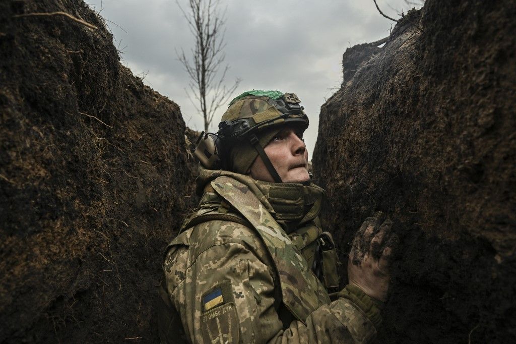 -- AFP PICTURES OF THE YEAR 2023 --

A Ukrainian serviceman takes cover in a trench during shelling next to a 105mm howitzer  near the city of Bakhmut, on March 8, 2023, amid the Russian invasion of Ukraine. (Photo by Aris Messinis / AFP) / AFP PICTURES OF THE YEAR 2023