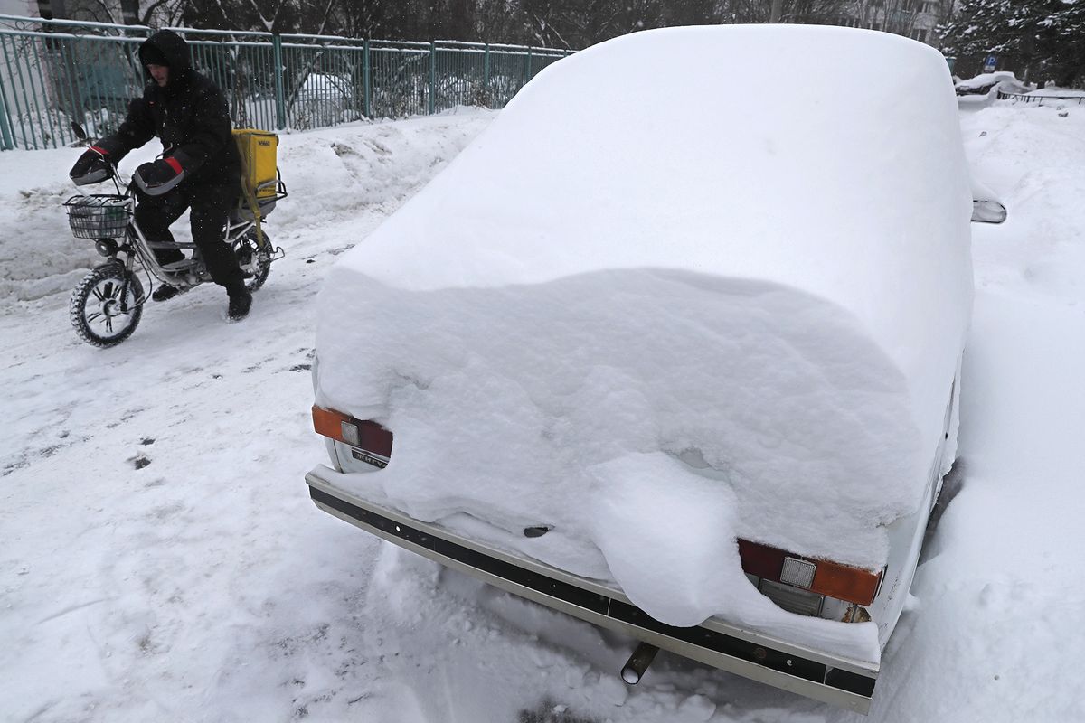 Snow covered old cars during winter in Moscow