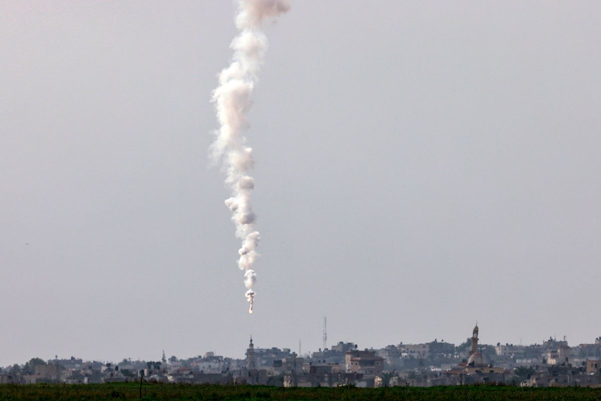 A picture taken from southern Israel near the border with the Gaza Strip on December 10, 2023, shows a flare fired by Israeli troops falling on Khan Yunis in the southern Gaza Strip, amid ongoing battles with the Palestinian Hamas militant group. Israeli forces pushed into southern Gaza on December 10, where hundreds of thousands of civilians have fled in search of shelter from bombardments and intense fighting with Hamas militants. (Photo by Menahem KAHANA / AFP)