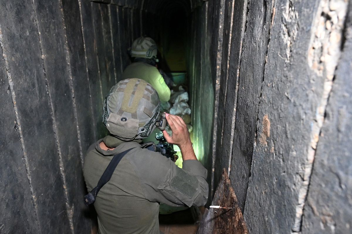 --PHOTO TAKEN DURING A CONTROLLED TOUR AND SUBSEQUENTLY EDITED UNDER THE SUPERVISION OF THE ISRAELI MILITARY-- Soldiers walk through what the Israeli army says is a tunnel dug by Hamas militants inside the Al-Shifa hospital complex in Gaza City in the northern Gaza Strip, amid continuing battles between Israel and the Palestinian militant group Hamas, on November 22, 2023. (Photo by Ahikam SERI / AFP)