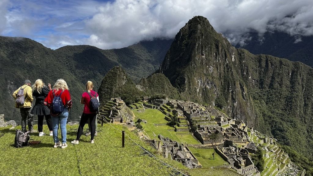 Tourists visit the ancient Inca ruins of Machu Picchu in the Urubamba valley, seventy-two kilometres from the Andes city of Cusco, on February 15, 2023, for the first time after they were closed to the public for security reasons on January 21, after protesters blocked the railways during protests against the government of President Dina Boluarte that have shaken the Andean country since December 7, 2022. (Photo by Carolina Paucar / AFP)