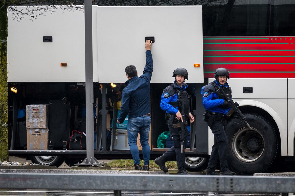 Police officers control a bus near Saint Maurice, as they search for a gunman who killed two people and injured another in the southern Swiss town of Sion, on December 11, 2023. A massive police operation was underway to find the 36-year-old man behind the mass shooting, a rare event in the wealthy Alpine nations. Police said he had fired shots at people in two distinct locations in the picturesque town in the Alpine Wallis region shortly before 8 am (0700 GMT). "Two people were killed and another was injured," regional police said in a statement, adding that the man's motives for carrying out the shootings remained unknown. (Photo by Fabrice COFFRINI / AFP)