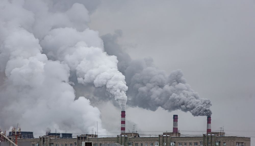 Industrial,Chimneys,With,Heavy,Smoke,Causing,Air,Pollution,On,The