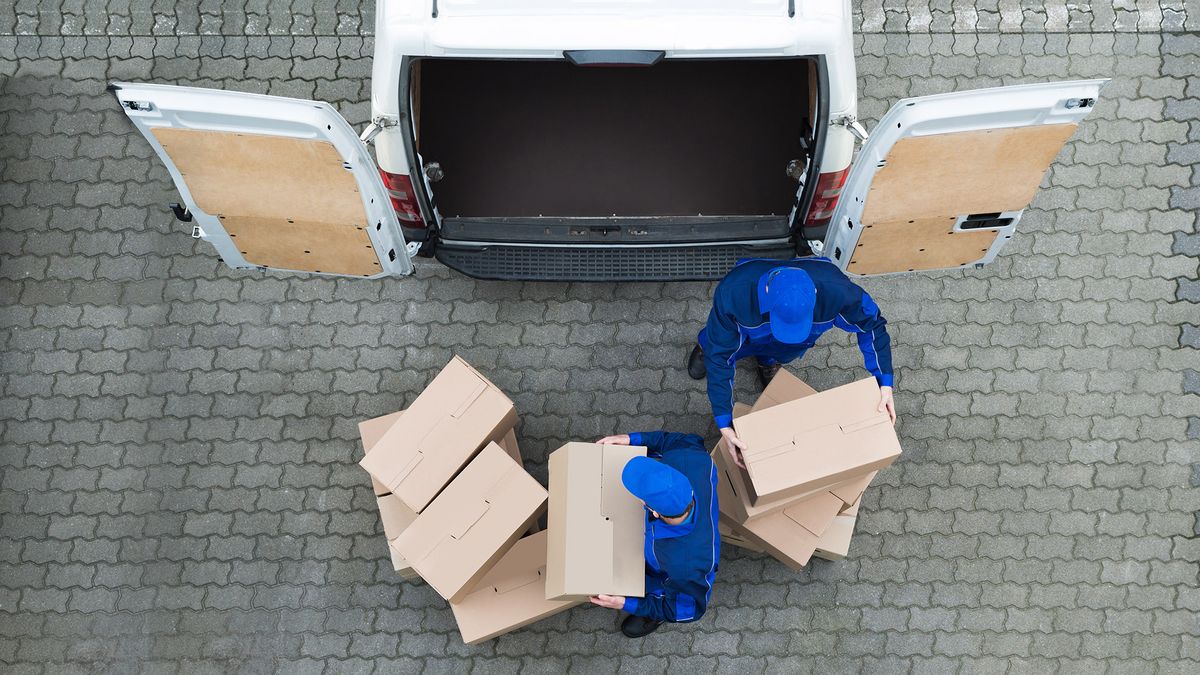 Directly,Above,Shot,Of,Delivery,Men,Unloading,Cardboard,Boxes,From