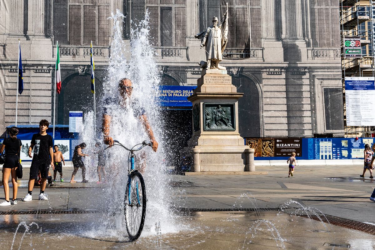 Nero Heatwave In Italy
Even the cyclists in Turin are seeking relief from the scorching Nero heatwave by taking a dip in the fountains.Currently, there is a red heat alert in effect in various cities throughout Italy. The temperatures are expected to exceed the norm due to the Nero anticyclone affecting the region. The Italian government recommends staying indoors during the afternoon when the heat is at its highest. It is important to stay hydrated by drinking plenty of water and to avoid any strenuous physical activities during the day, in Turin, Italy, on august 22, 2023. (Photo by Mauro Ujetto/NurPhoto) (Photo by Mauro Ujetto / NurPhoto / NurPhoto via AFP)