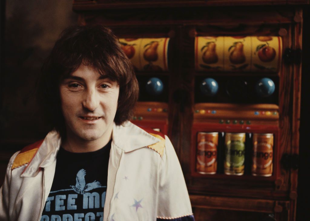 Denny Laine
English singer-songwriter and former Wings and Moody Blues guitarist, Denny Laine poses in front of two slot machines in 1981. (Photo by Michael Putland/Getty Images)