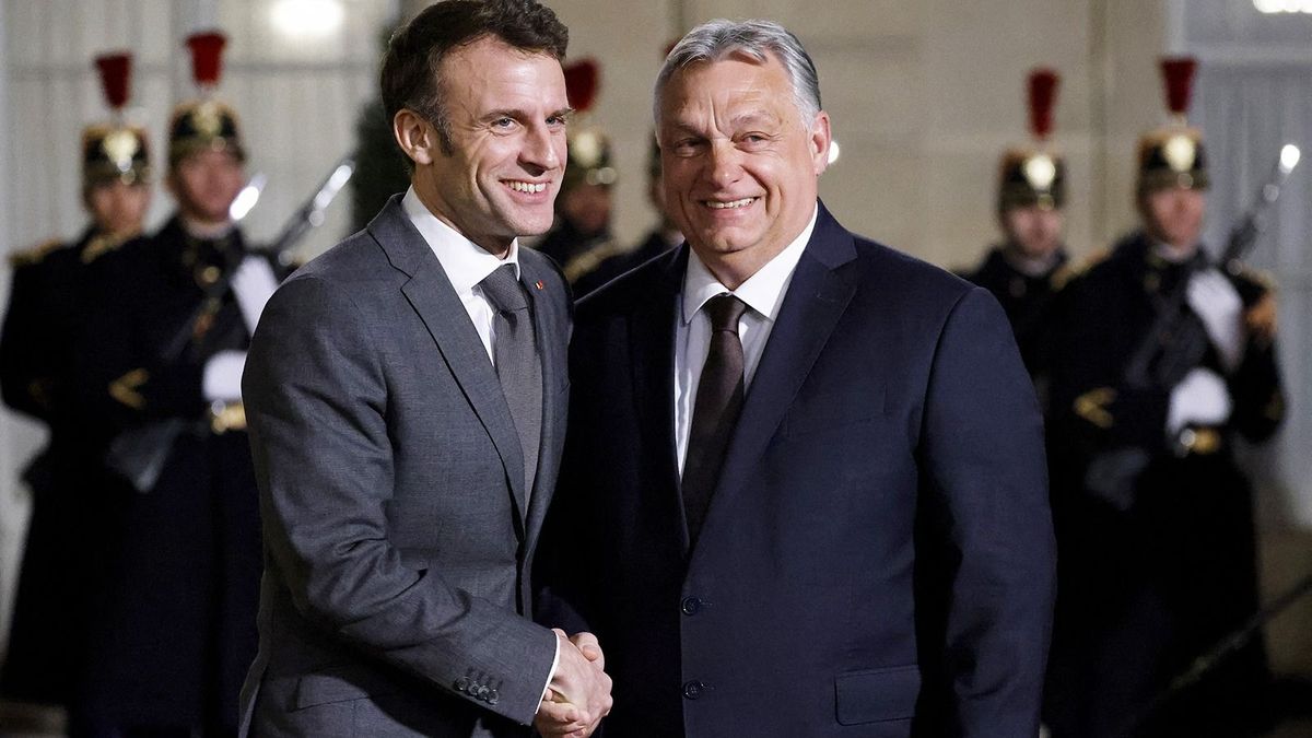France's President Emmanuel Macron (C) shakes hands with Hungarian Prime Minister Viktor Orban (R), before a working dinner at the Elysee Presidential Palace in Paris on March 13, 2023. (Photo by Ludovic MARIN / AFP)