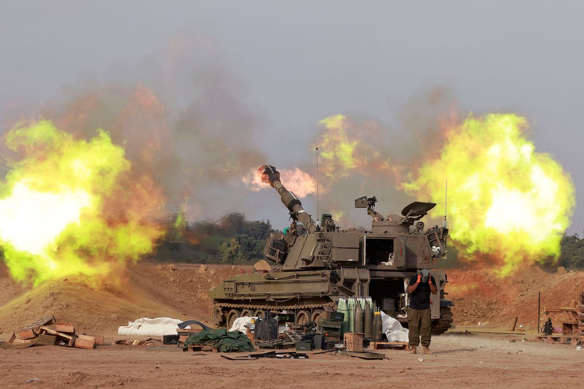 An Israeli army self-propelled artillery howitzer fires rounds from a position near the border with the Gaza Strip in southern Israel on December 7, 2023 amid battles between Israel and the Palestinian group Hamas in the Gaza Strip. (Photo by Menahem Kahana / AFP)