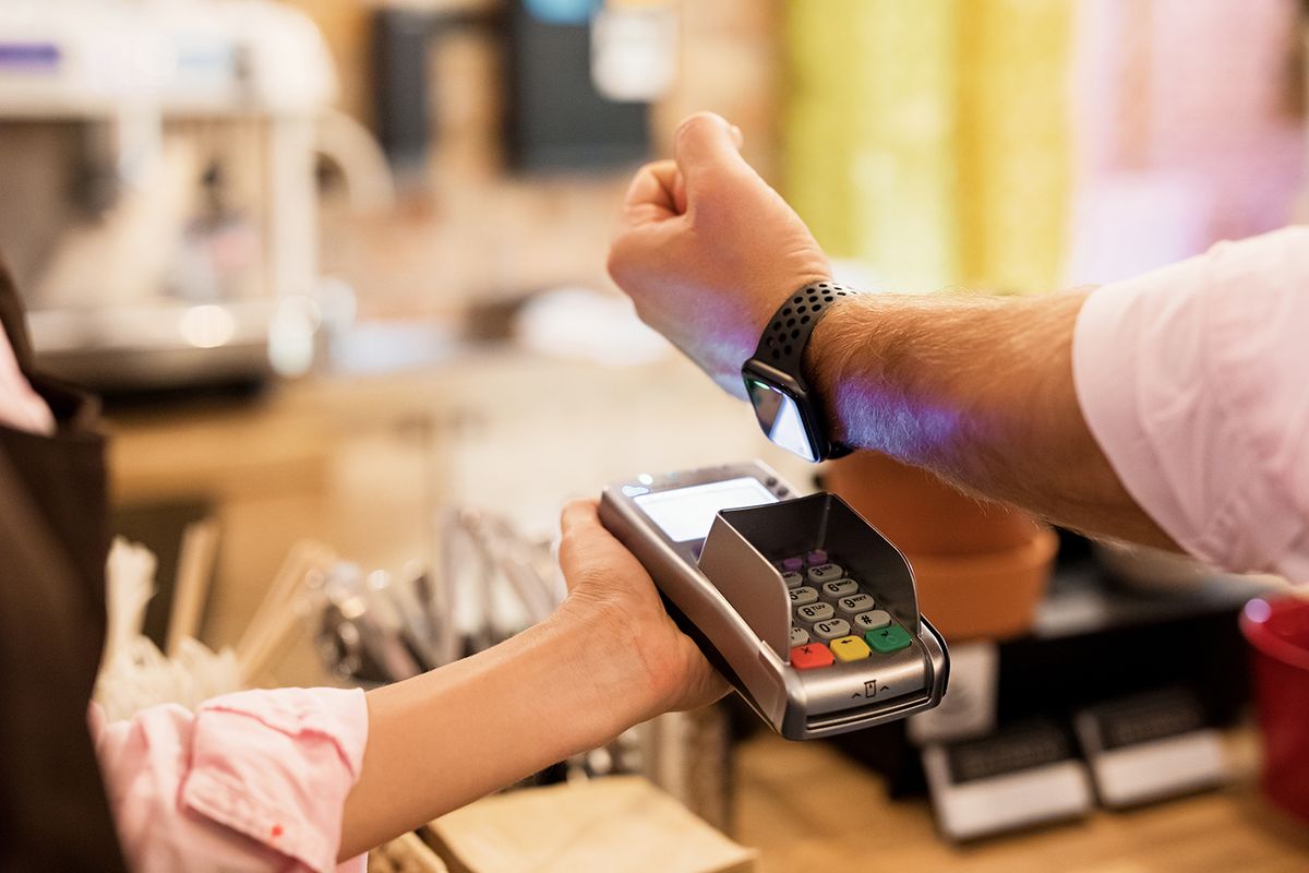 Person,Paying,At,Cafe,With,Smart,Watch,Wirelessly,On,Pos