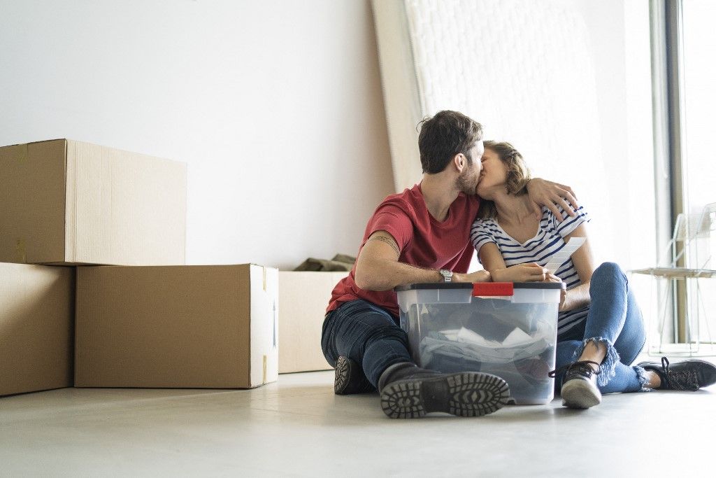 Young couple kissing in their new house