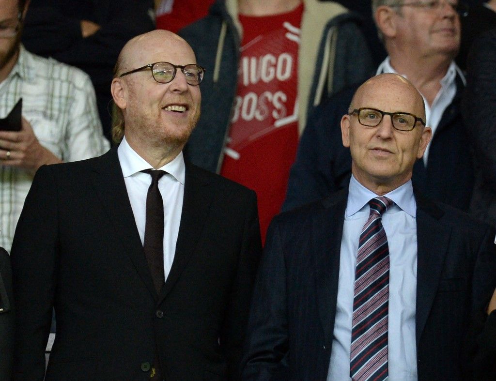 Manchester United's US co-chairmen Joel Glazer (R) and Avram Glazer (L) attend the English Premier League football match between Manchester United and Southampton at Old Trafford in Manchester, north west England, on August 19, 2016. (Photo by Oli SCARFF / AFP) / RESTRICTED TO EDITORIAL USE. No use with unauthorized audio, video, data, fixture lists, club/league logos or 'live' services. Online in-match use limited to 75 images, no video emulation. No use in betting, games or single club/league/player publications. / 