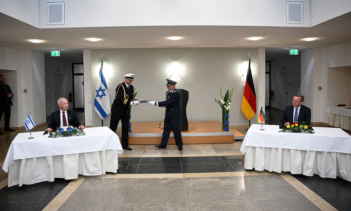 Documents are exchanged as German Defence Minister Boris Pistorius (R) and Israeli Defence Minister Yoav Gallant sign a Declaration of Intent on the ARROW 3 missile defence project at the Defence Ministry in Berlin on September 28, 2023. Germany signed a deal to acquire the Israeli-made Arrow 3 hypersonic missile system that will become a key part of Europe's defence against air attack.The signing of the deal was a "historic day" for both countries, German Defence Minister Boris Pistorius said at a press conference alongside his Israeli counterpart Yoav Gallant. (Photo by Tobias SCHWARZ / AFP)