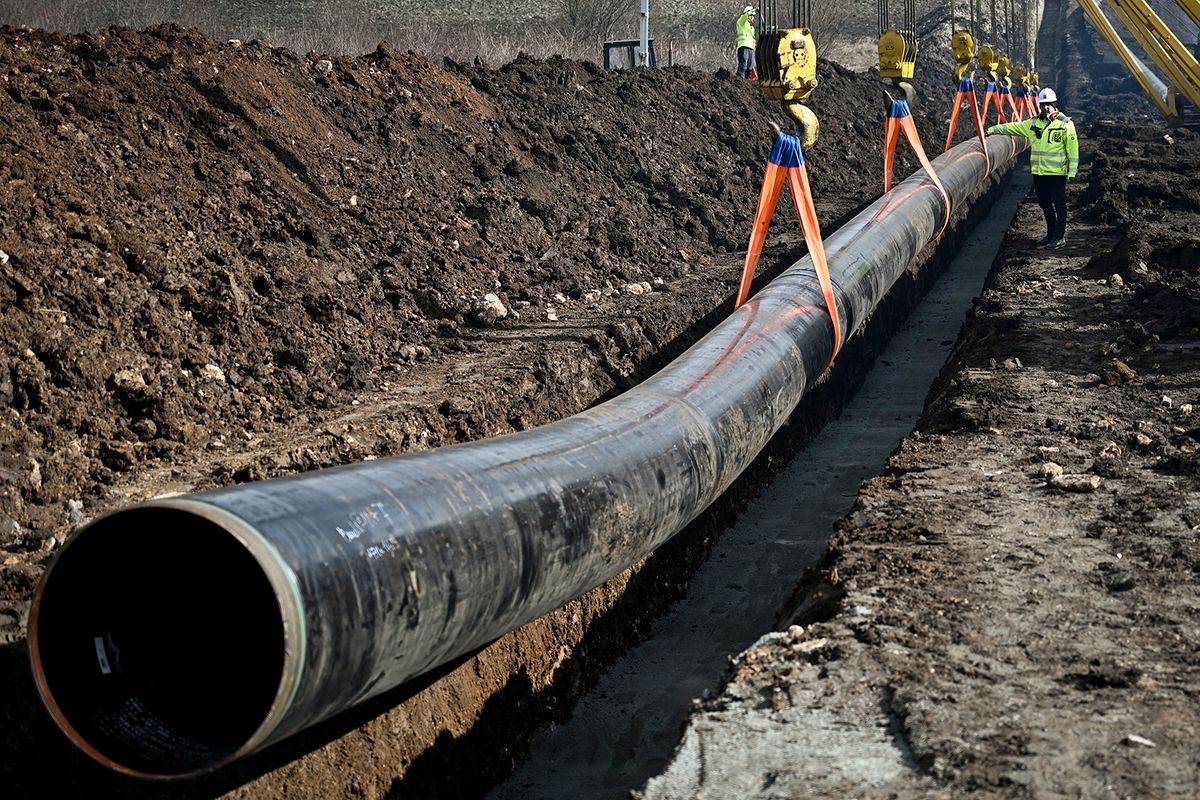 A worker walks past a pipe at the construction site of the Bulgaria-Serbia gas pipeline, near Kostinbrod, on February 1, 2023. Bulgaria launched construction on February 1 of a long-delayed gas pipeline link to neighbouring Serbia in a bid to boost security of gas deliveries in the eastern Balkans amid Russia's invasion of Ukraine. (Photo by Nikolay DOYCHINOV / AFP)