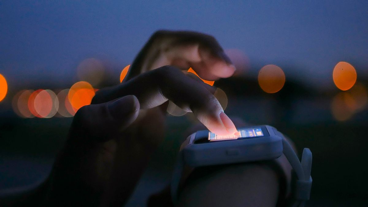 Young,Woman,Using,Wearable,Smartwatch,Computer,Device,In,The,City.