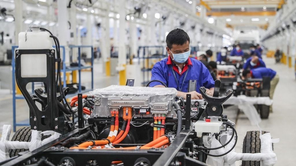 An employee works on a new energy vehicle assembly line at a BYD factory in Huaian in China's eastern Jiangsu province on July 6, 2020. (Photo by AFP) / China OUT