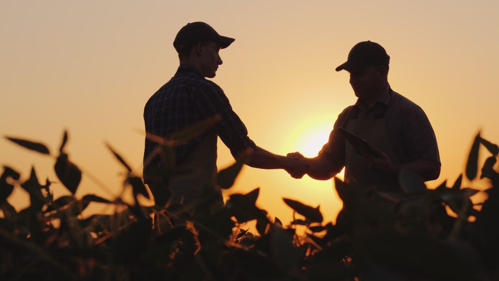 Two,Farmers,Talk,On,The,Field,,Then,Shake,Hands.,Use