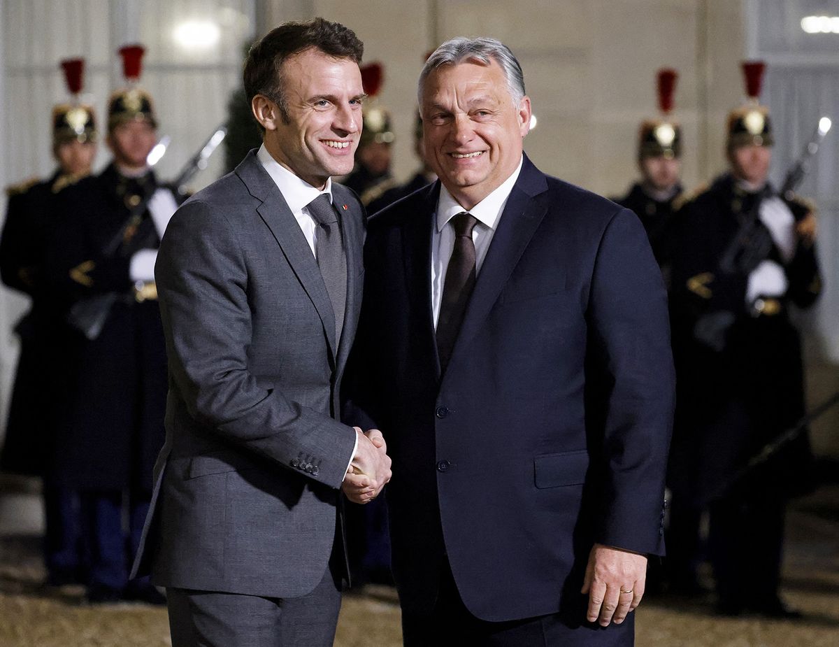 France's President Emmanuel Macron (C) shakes hands with Hungarian Prime Minister Viktor Orban (R), before a working dinner at the Elysee Presidential Palace in Paris on March 13, 2023. (Photo by Ludovic MARIN / AFP)