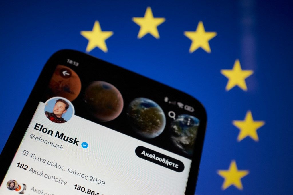 Elon Musk - European Union (EU)In this photo illustration Elon Musk Twitter seen displayed on a smartphone screen with the flag of European Union (EU) in the background in Athens, Greece on March 8, 2023. The European Union is asking Elon Musk to hire staff at Twitter. (Photo Illustration by Nikolas Kokovlis/NurPhoto) (Photo by Nikolas Kokovlis / NurPhoto / NurPhoto via AFP) 