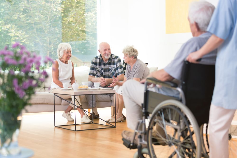 Group,Of,Elderly,People,Sitting,On,The,Sofa,During,Lunch