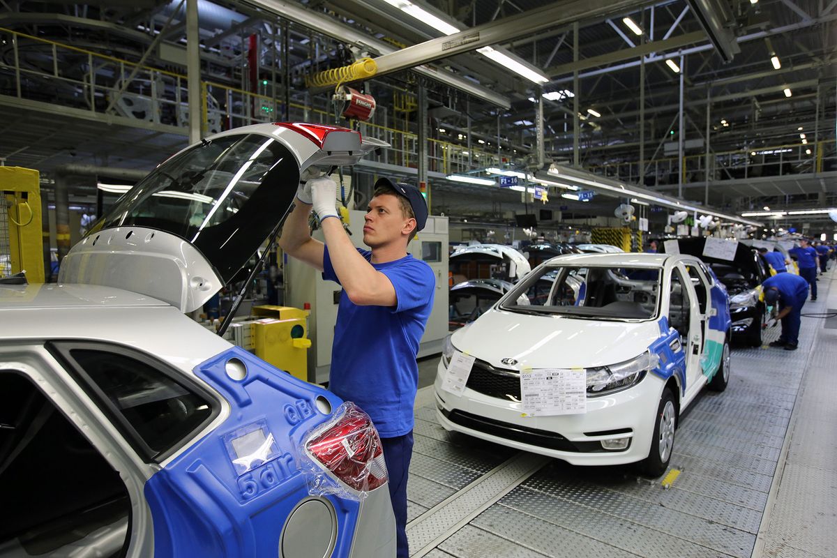 Automobile Production At The Hyundai Motor Manufacturing RUS Plant
A worker assembles components to the rear door on a Kia Rio vehicle on the production line at the Hyundai Motors Corp. automobile plant in St Petersburg, Russia, on Friday, Aug. 14, 2015. By volume, Hyundai Kia is the largest automaker in Russia, holding that position as its 15% decline in unit year-to-date sales is the third best performance of all automakers selling in Russia. Photographer: Andrey Rudakov/Bloomberg via Getty Images