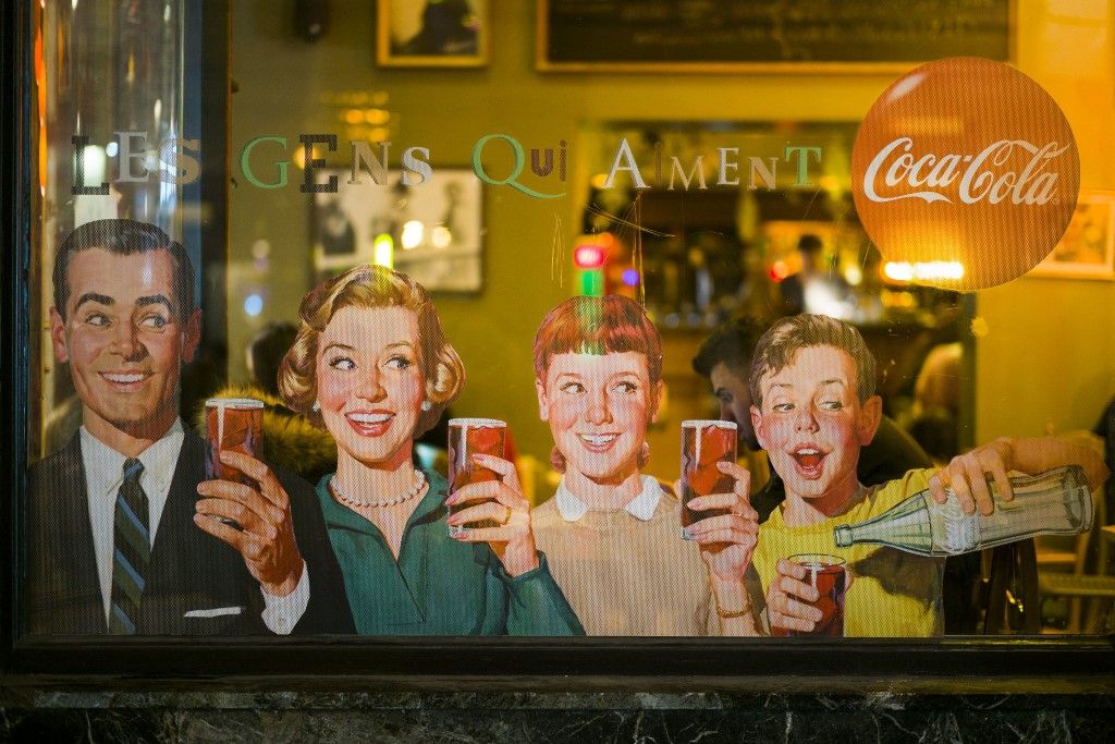 Belgium, Brussels, vintage Coca-Cola sign on cafe, evening (Photo by BIBIKOW Walter / Hemis.fr / hemis.fr / Hemis via AFP)