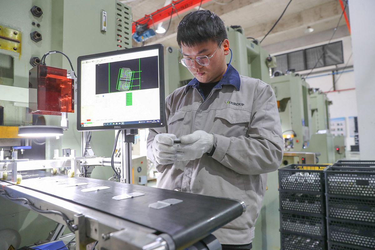 HUZHOU, CHINA - NOVEMBER 20, 2023 - A worker produces battery parts for new energy vehicles for export in Huzhou, Zhejiang province, China, November 20, 2023. (Photo by Costfoto/NurPhoto) (Photo by CFOTO / NurPhoto / NurPhoto via AFP)