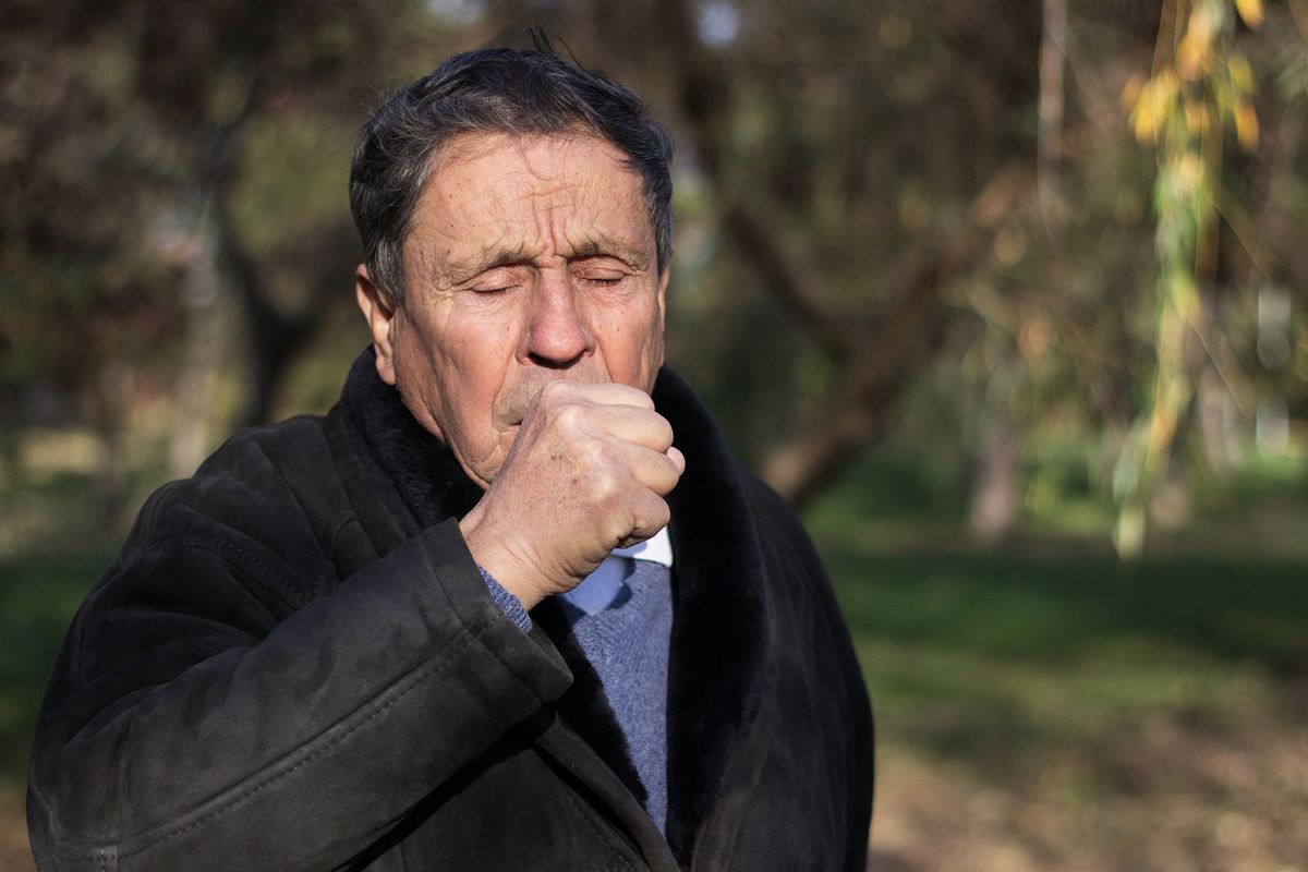 Portrait,Of,A,Coughing,Senior,Man,Outdoors,,Looking,Down.,Senior