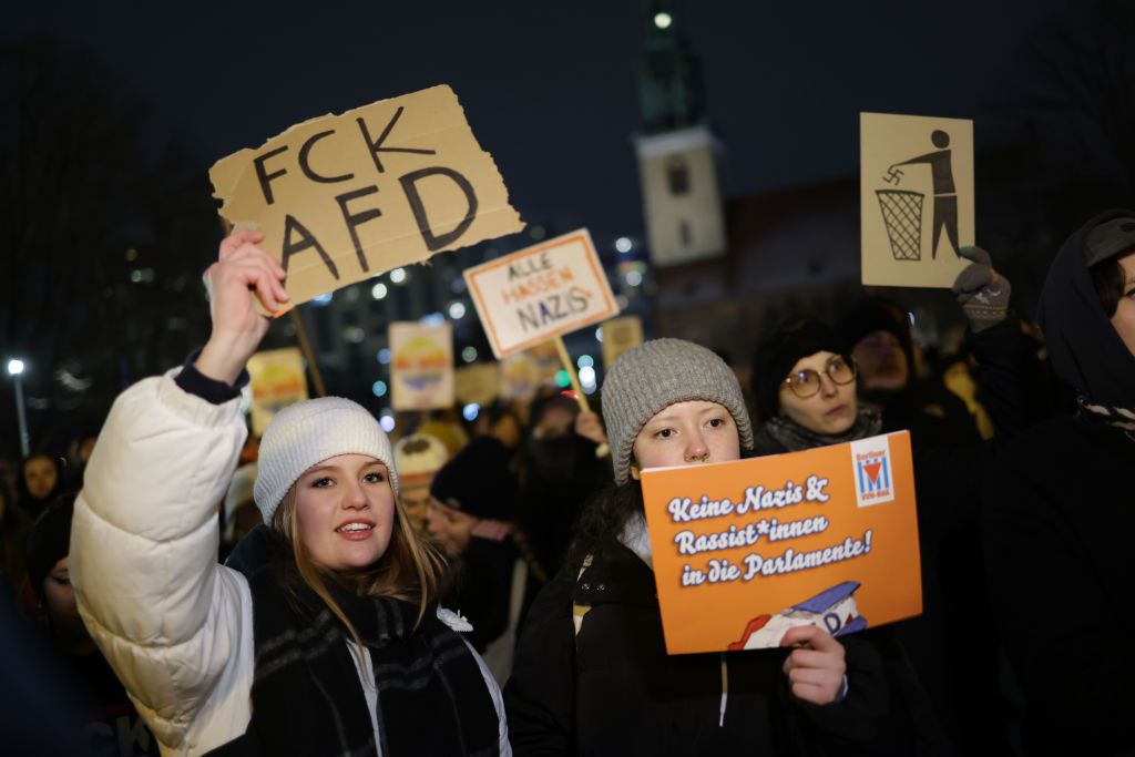 People Protest Against AfD Following AfD Meeting With Neo-NazisBERLIN, GERMANY - JANUARY 17: (EDITORS NOTE: Image contains profanity.) People gather in the city center to protest against the far-right Alternative for Germany (AfD) political party on January 17, 2024 in Berlin, Germany. Several thousand people gathered today in Berlin in one of a number of similar protests this week across Germany. The AfD is under heavy public scrutiny following the recent revelation that Roland Hartwig, a former AfD Bundestag parliamentarian and until recently an advisor to AfD co-leader Alice Weidel, had taken part in a meeting last year with neo-Nazis, including Austrian far-right extremist Martin Sellner, at a villa near Potsdam. According to the investigative group Correctiv participants at the meeting discussed how to possibly introduce legislative measures to enable the mass expulsion of immigrants from Germany, as well as German citizens with immigrant roots and German citizens who have helped refugees. News of the meeting has prompted renewed calls for banning the AfD.   (Photo by Sean Gallup/Getty Images)